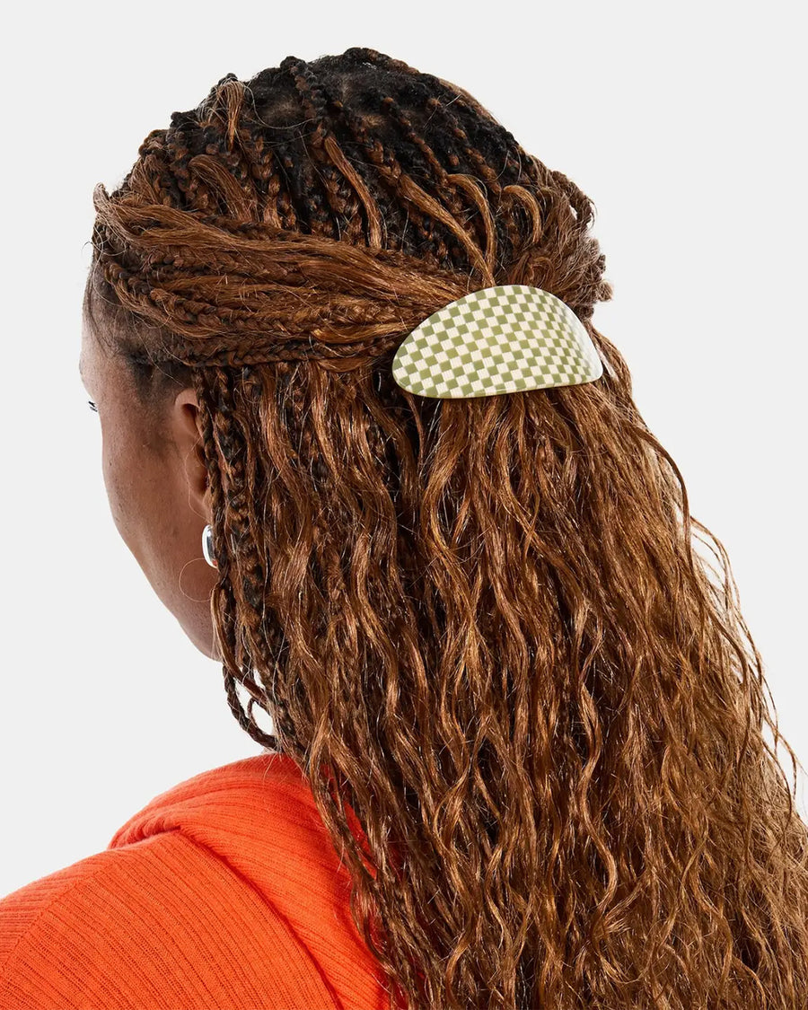 model wearing green and white checkered oval barrette