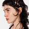 model wearing black and red bobby pins and tin with dangling picnic charms