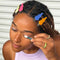 model wearing set of 4 wavy setting clips in solid lime green, bright blue, hot pink, and orange