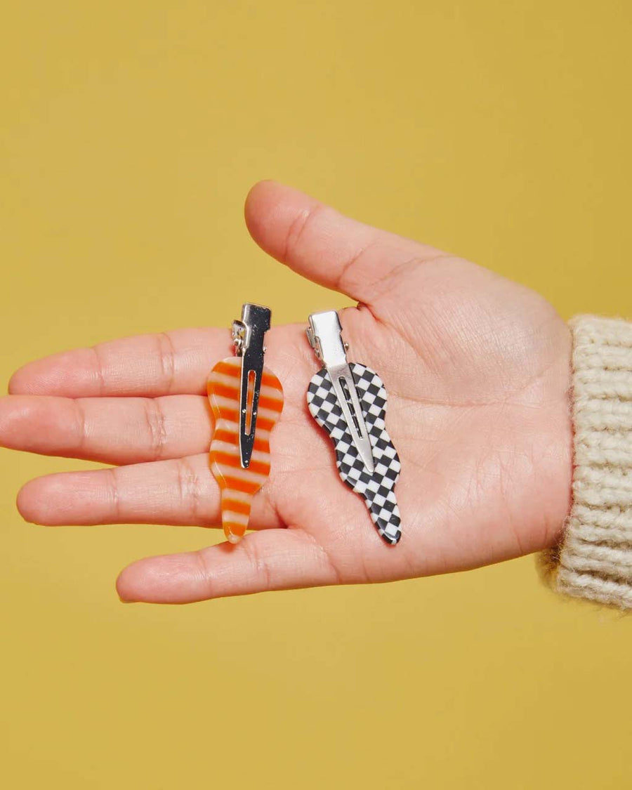 model holding orange and pink stripe and black and white checkered
