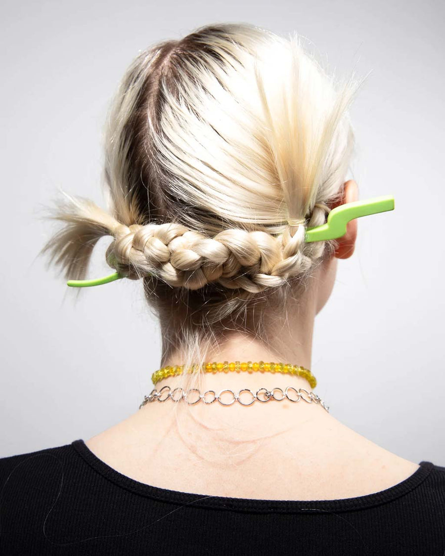 model wearing lime green small wavy hair stick