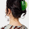 model wearing lime green translucent hair claw with wavy edges