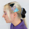 model wearing set of three heart hair clips: black heart with blue rhinestones, lavender heart with hollow center and blue heart with squiggle design