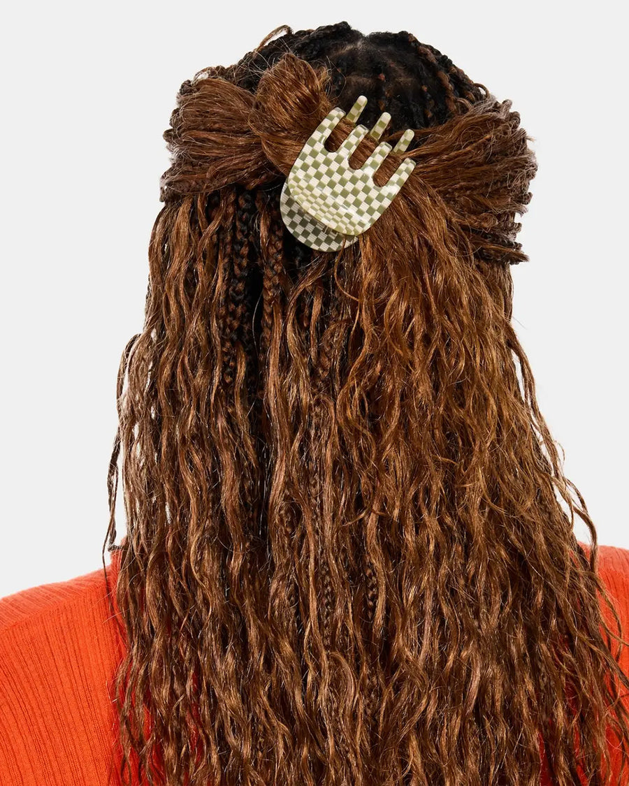 model wearing green and white checkered hair claw