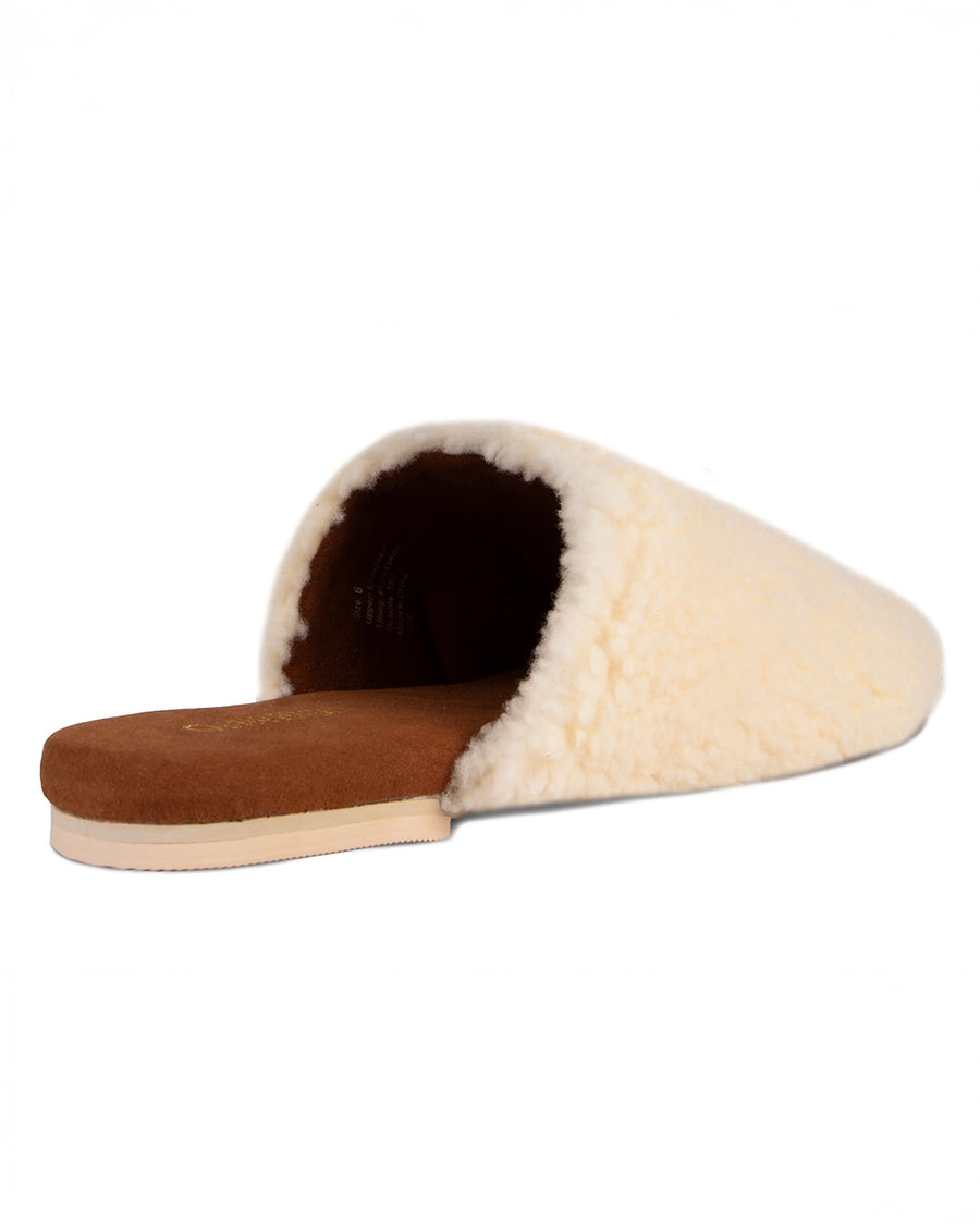back view of cream fuzzy sheepskin slip-on mule slippers