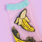 up close of pair of sheer socks with banana print and aqua trim