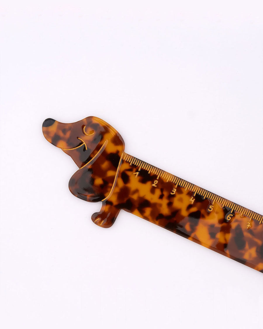 up close of yellow etching on tortoise shell dachshund shaped ruler