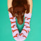 model wearing lilac socks with dachshund socks with a dachshund laying on their legs