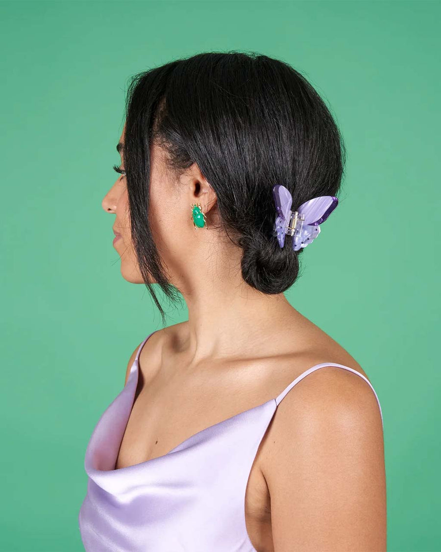 model wearing purple butterfly hair claw