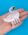 model holding white swan shaped hair claw