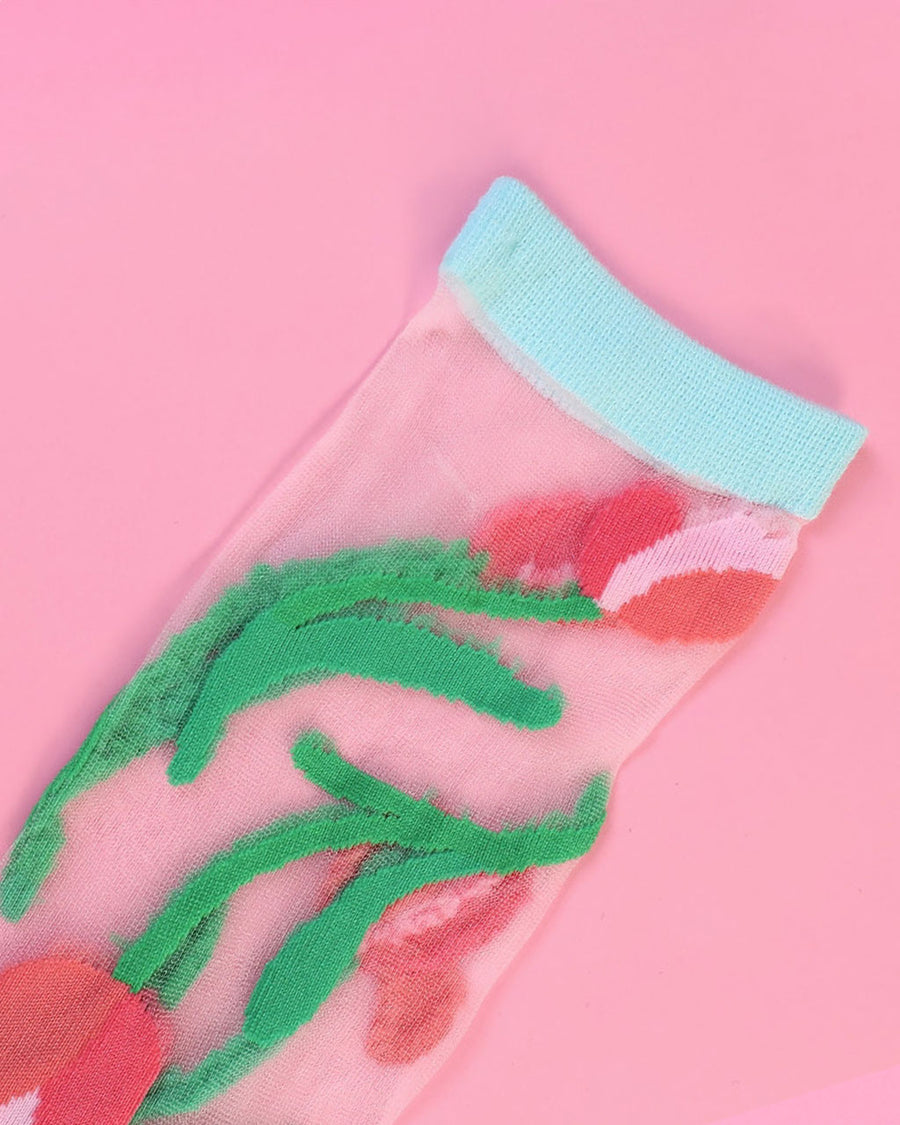 up close of sheer socks with mint trim and pink tulip print