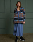 model wearing blue and brown wool plaid jacket