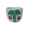 front view of blue mug with scalloped top and 3D cherry design on the green handle