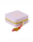 side view of purple jewelry case with multicolor tassel and gold 'bits & pieces' across the front