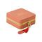 side view of coral jewelry case with multicolor tassel and gold 'you're a gem, you know that?' across the front