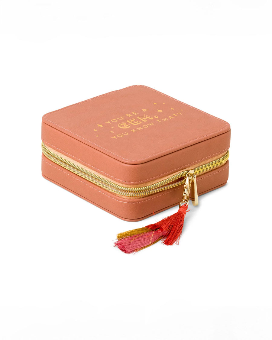 side view of coral jewelry case with multicolor tassel and gold 'you're a gem, you know that?' across the front