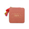 coral jewelry case with multicolor tassel and gold 'you're a gem, you know that?' across the front