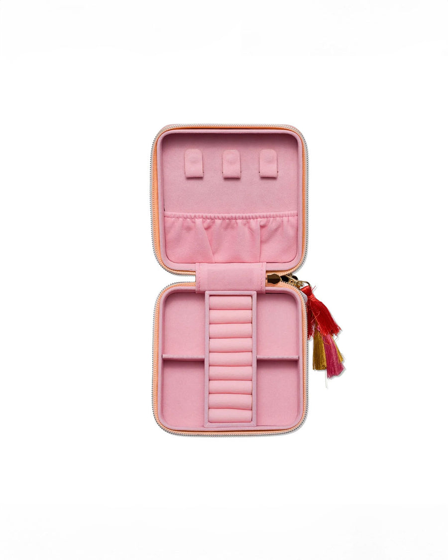 light pink interior of coral jewelry case with multicolor tassel and gold 'you're a gem, you know that?' across the front