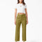 model wearing green crop ankle pants and white tee