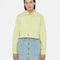 model wearing cropped pale green button up top woth collar and extended front patch pockets