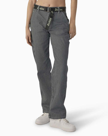 model wearing black and white thin pinstripe carpenter pants with black dickies belt