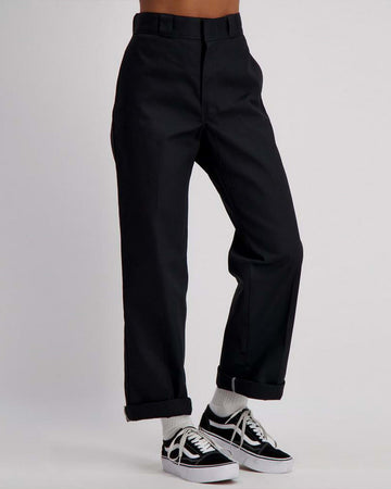 model wearing black trousers with front seams, belt loops and hook and eye closure