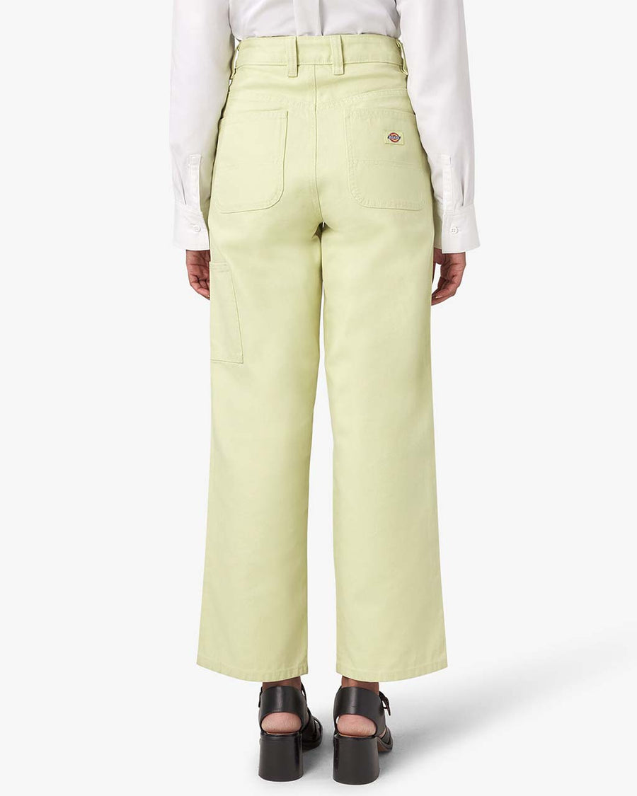 back view of model wearing pale green regular fit duck canvas pants