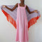 model wearing bubblegum pink cotton maxi dress with square neckline and patch pockets with bright yellow trim