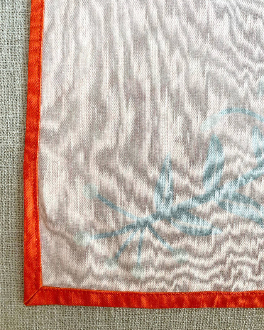 white backside of red tea towel with abstract wildflower print
