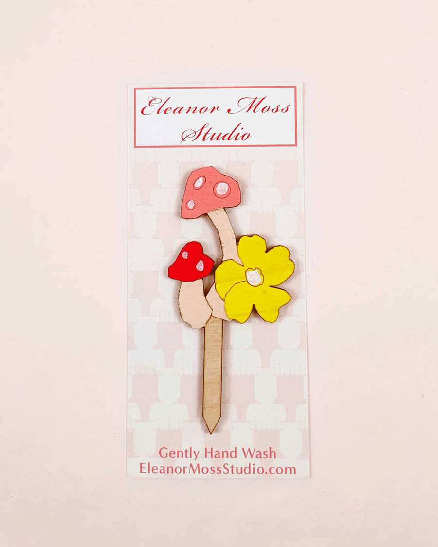 wooden pink and red mushroom and yellow flower cake topper