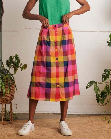 model wearing colorful plaid midi skirt with colorful button front