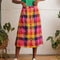 model wearing colorful plaid midi skirt with colorful button front