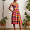 model wearing colorful plaid midi dress with fitted bodice and pockets
