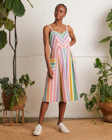 model wearing colorful vertical striped midi sundress with side patch pockets and colorful button front