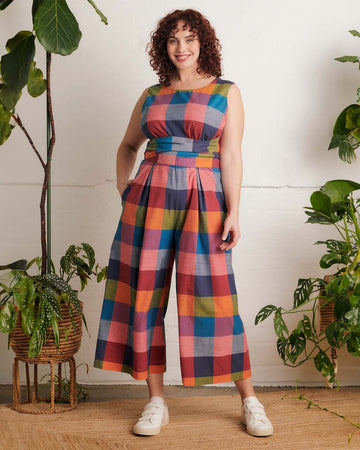 model wearing colorful plaid cropped leg jumpsuit with tie waist