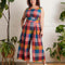 model wearing colorful plaid cropped leg jumpsuit with tie waist