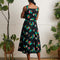 back view of model wearing black tank midi dress with colorful summer fruit print