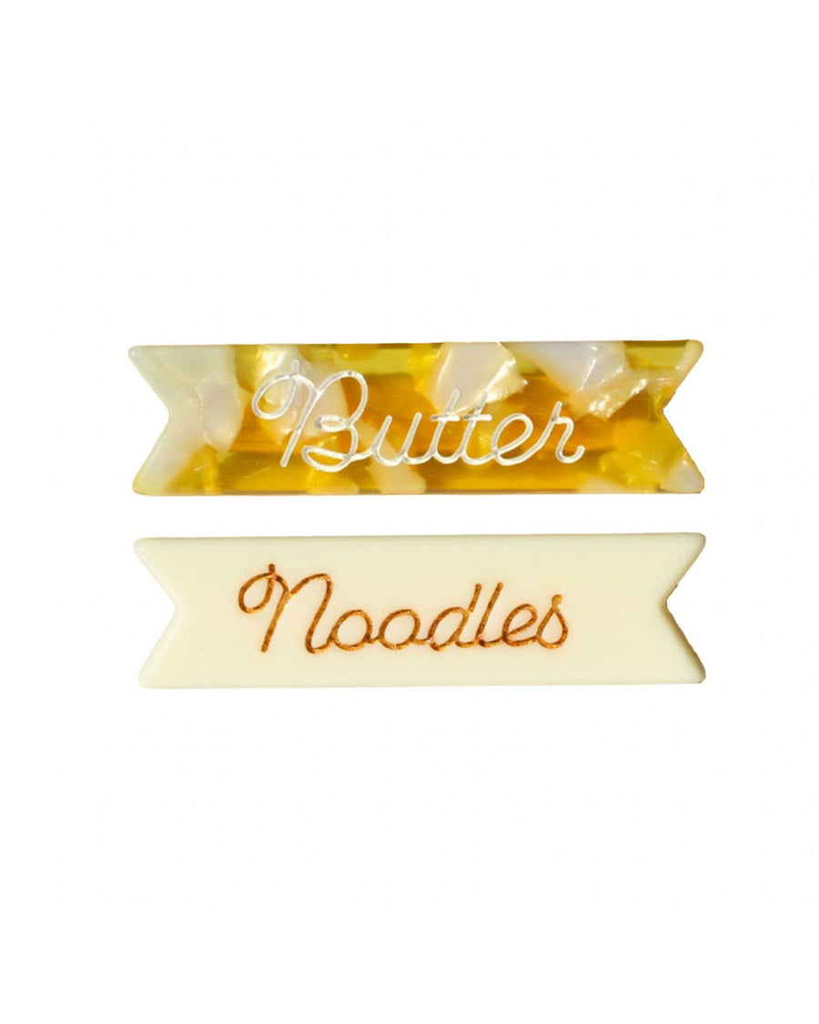 set of 2 hair clips: yellow marbled with white 'butter' and cream with gold 'noodles' on it.
