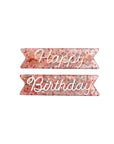 pink glittery hair clips with white 'happy' and 'birthday' on them