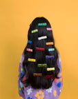 model wearing various velvet hair clips in assorted colors