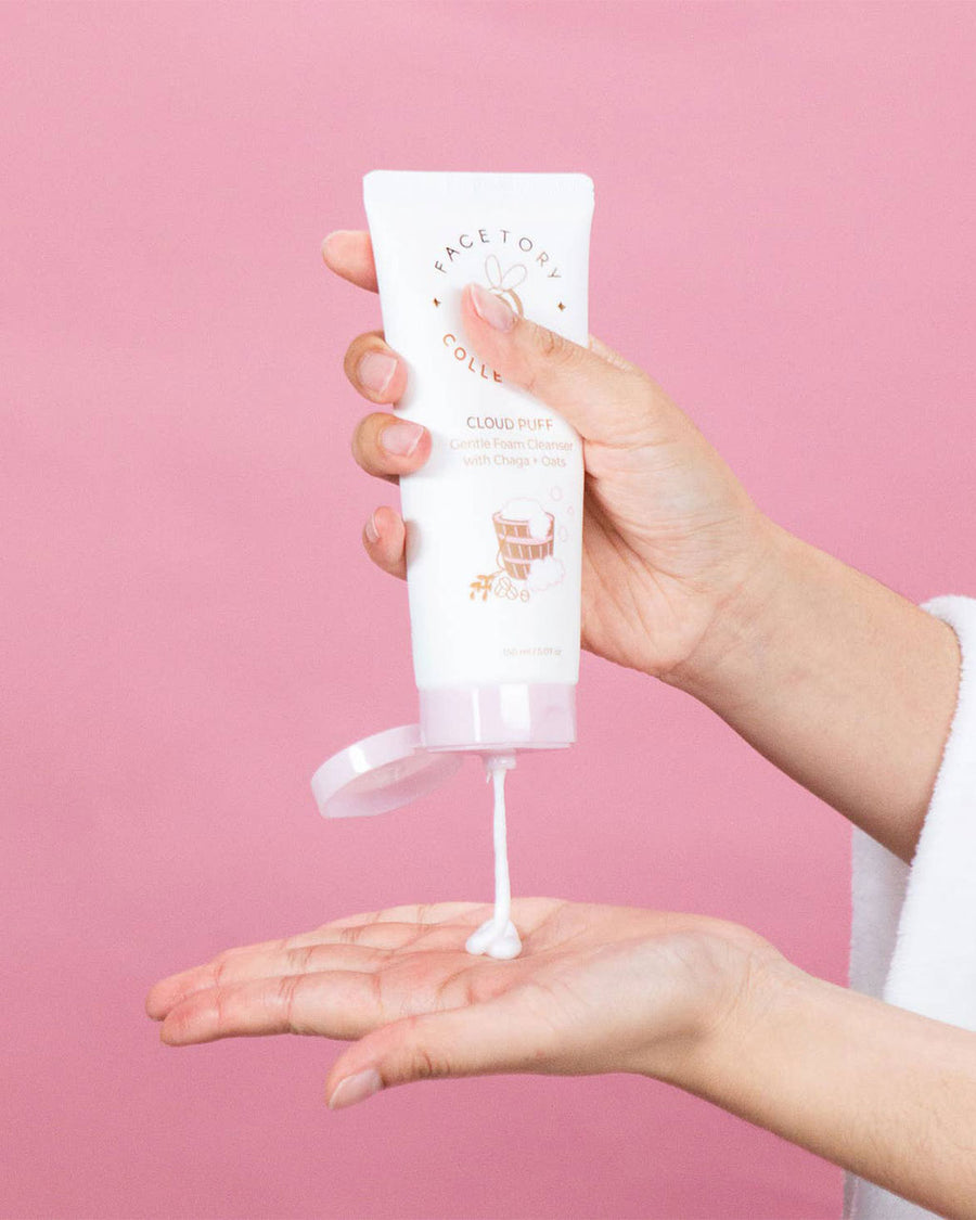 model squeezing facetory cloud puff gentle foam cleanser into their hand