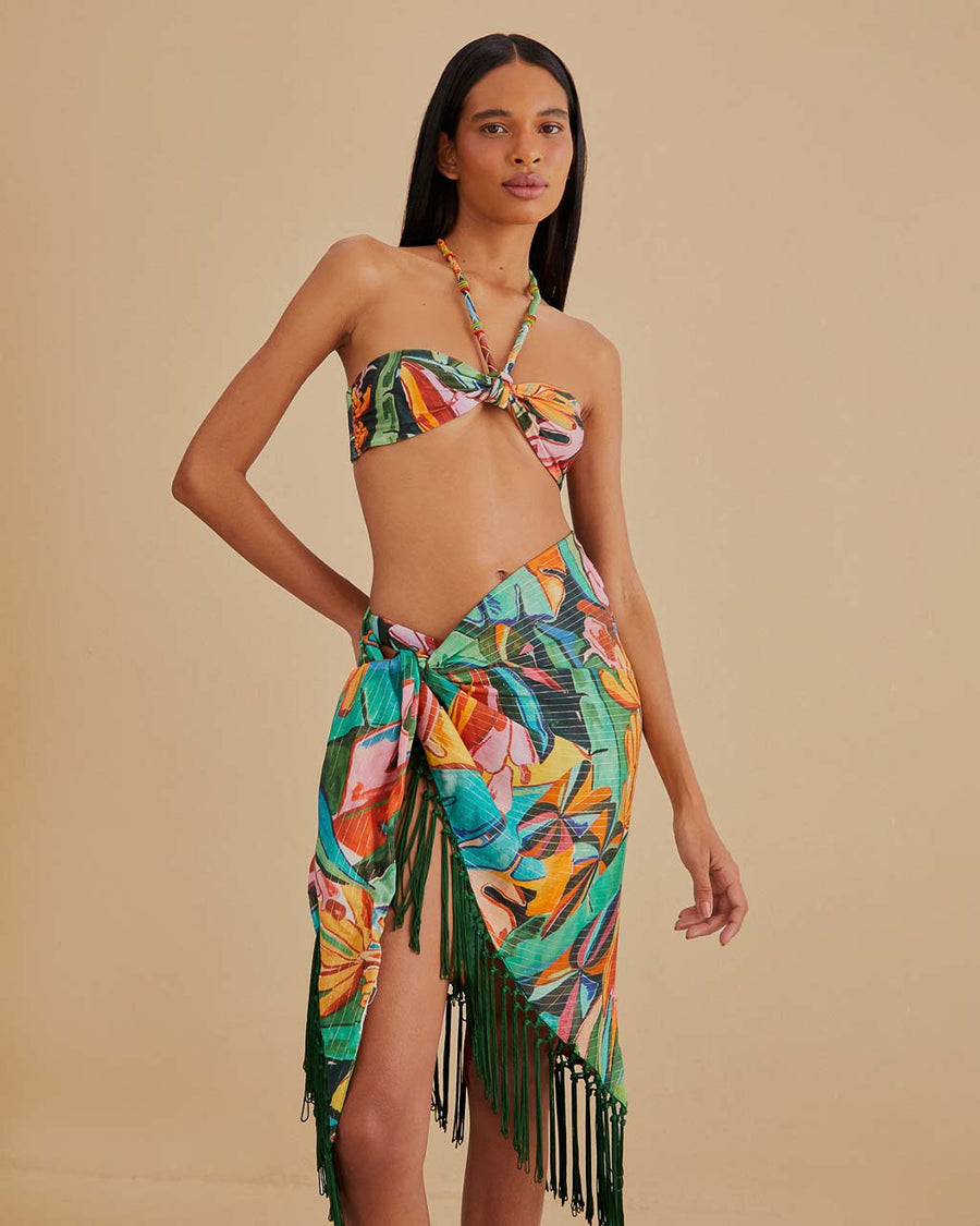 model wearing teal beach sarong with colorful banana and banana leaves print and green fringe