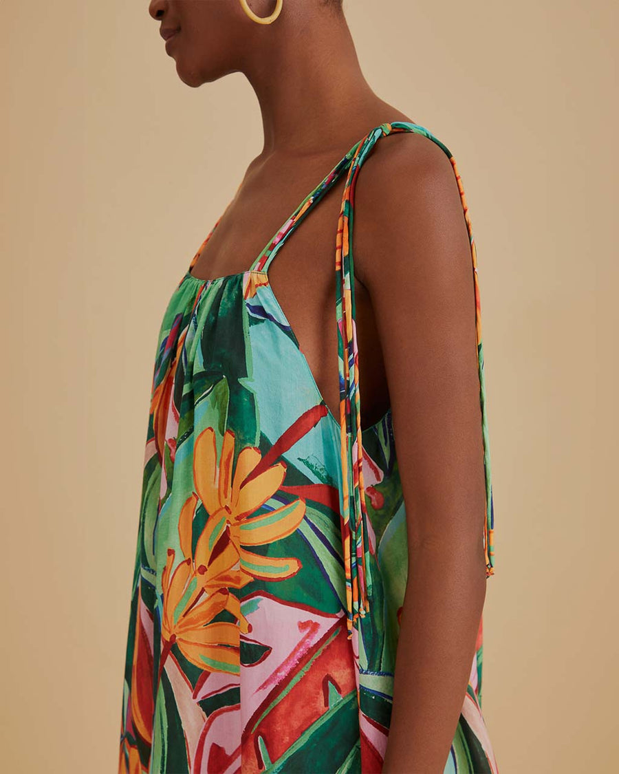 up close of model wearing green abstract print midi sundress with kerchief hem and tie shoulder straps