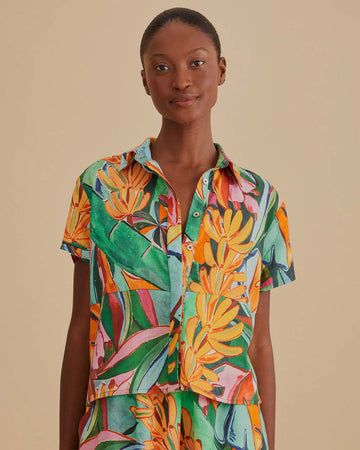 model wearing short sleeve button down with vibrant banana print