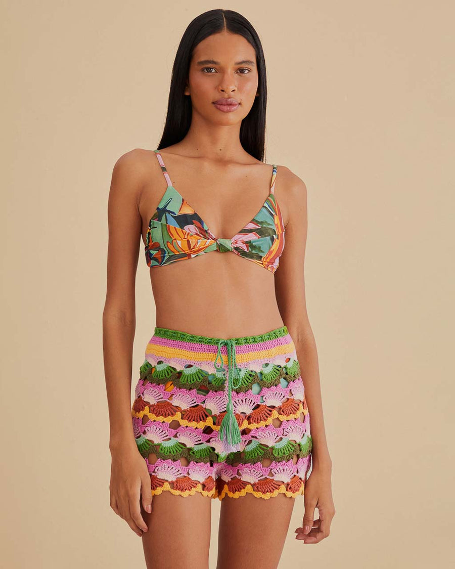 model wearing colorful crochet shorts with crochet tie and scalloped hem