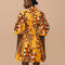 back view of model wearing abstract banana print mini dress with scrunched sleeves and button front