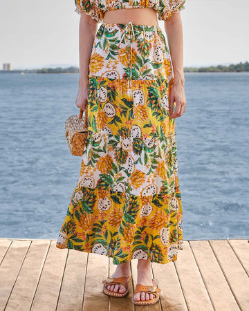 model wearing yellow and white mixed fruit tiered maxi skirt with tie waist