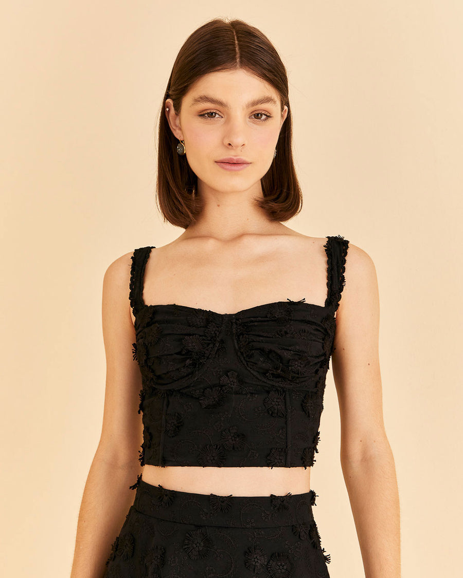 model wearing black corset tank with flower textured detail