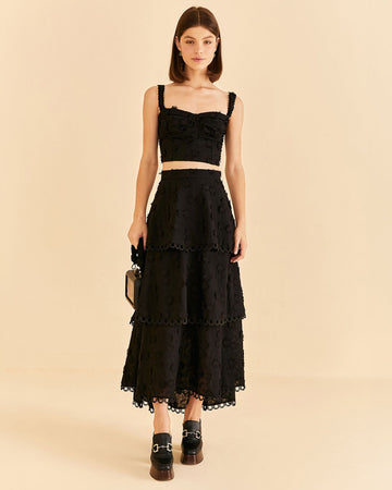 model wearing tiered lace black maxi skirt with 3D flower textured detail and matching top 