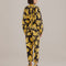 back view of model wearing black long sleeve jumpsuit with abstract banana print